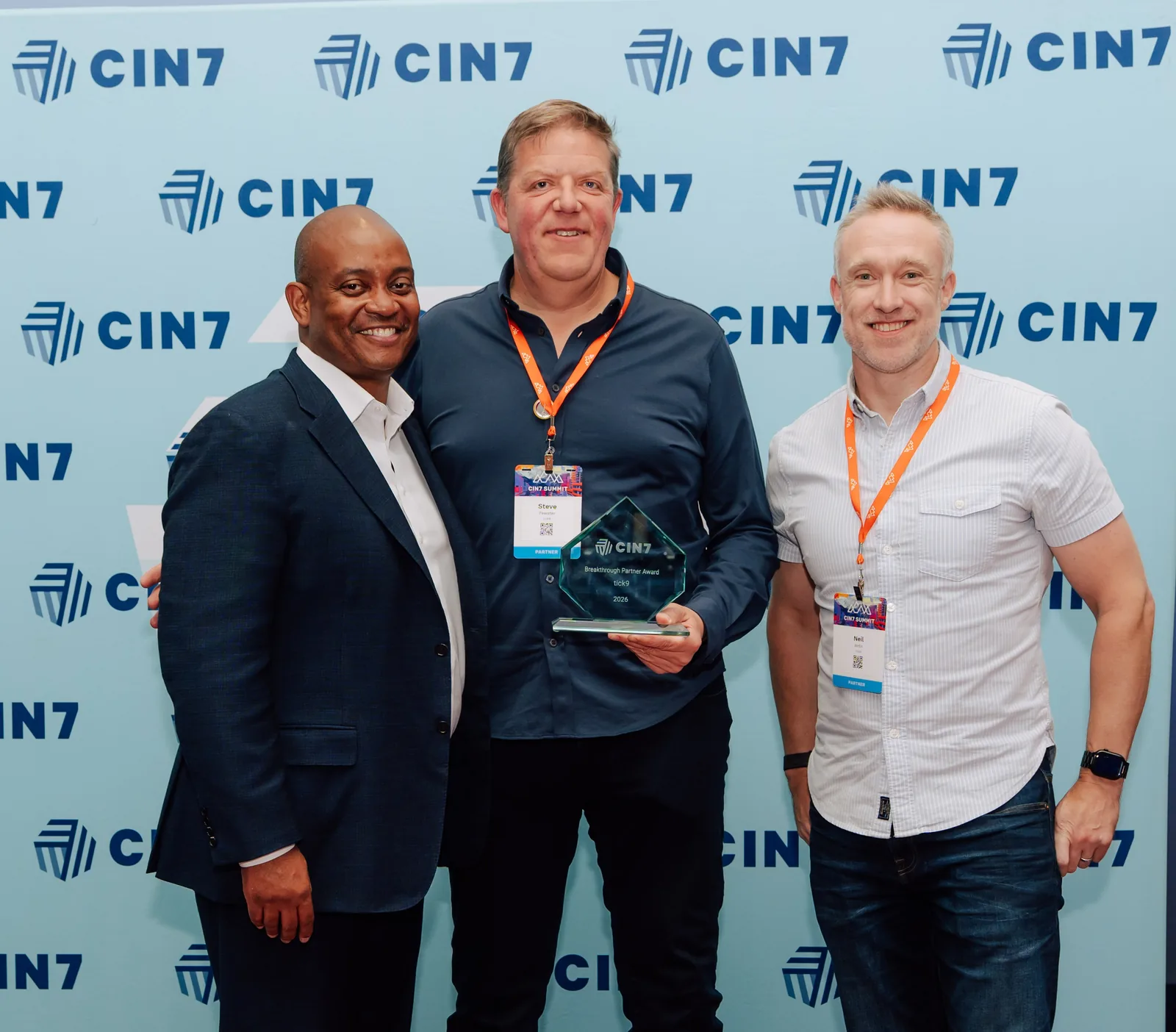 Sheldon Cummings, Stephen Fewster and Neil Wells with the Cin7 Breakthrough Partner Award trophy at Cin7 Summit 2026 in Denver